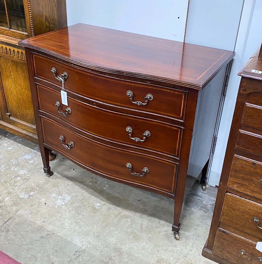 An Edwardian satinwood banded serpentine front inlaid mahogany three drawer chest, width 91cm, depth 51cm, height 84cm